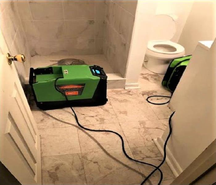 Sewage clean up in affected basement bathroom 