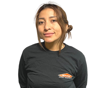 dark haired woman in SERVPRO shirt against white backdrop