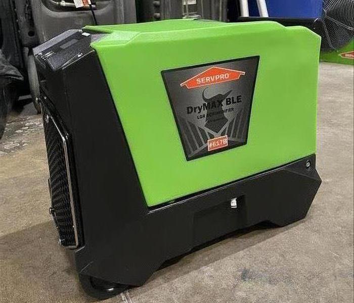 Green Phoenix DryMAX BLE Dehumidifier placed on the floor of a warehouse